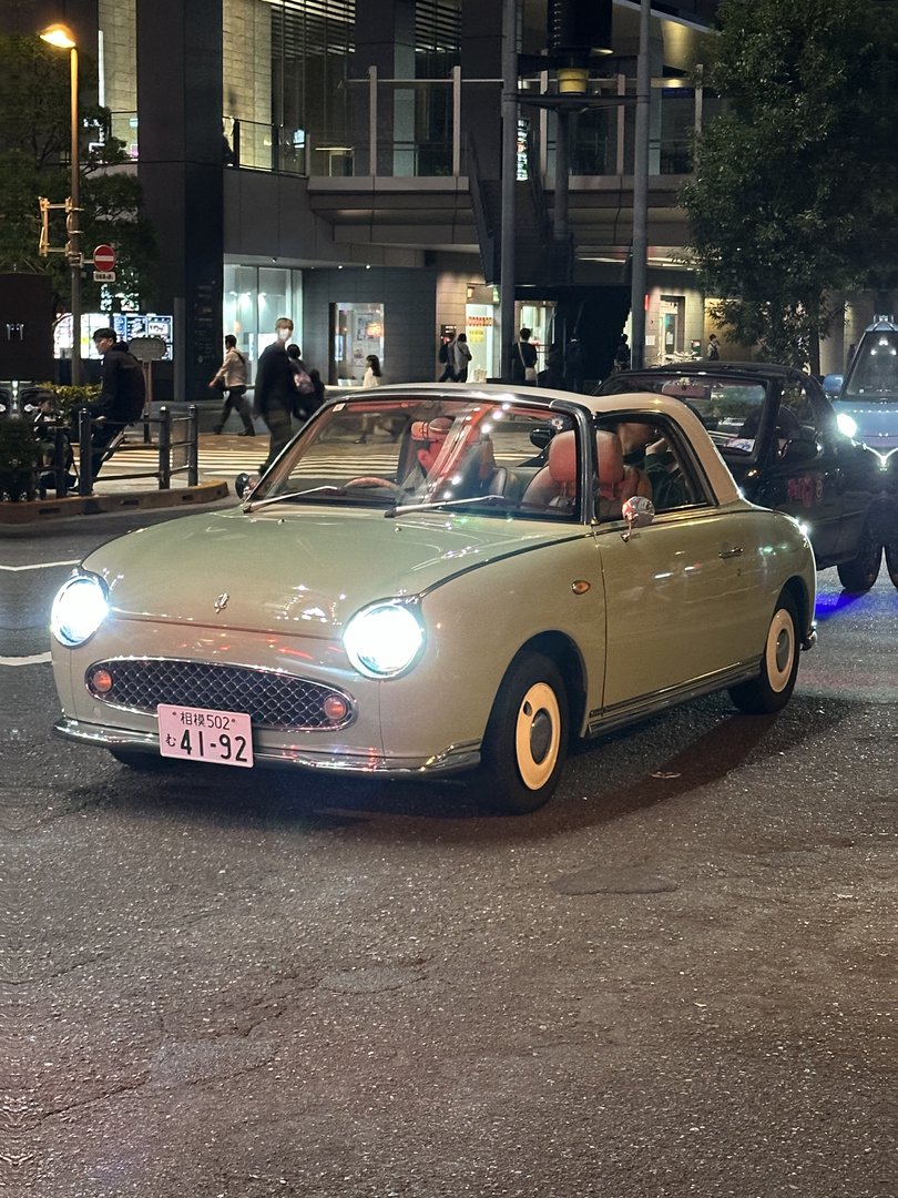 spotted this ADORABLE vintage nissan figaro cruising through akihabara at night - such a perfect match for the retro-tech vibe of electric town