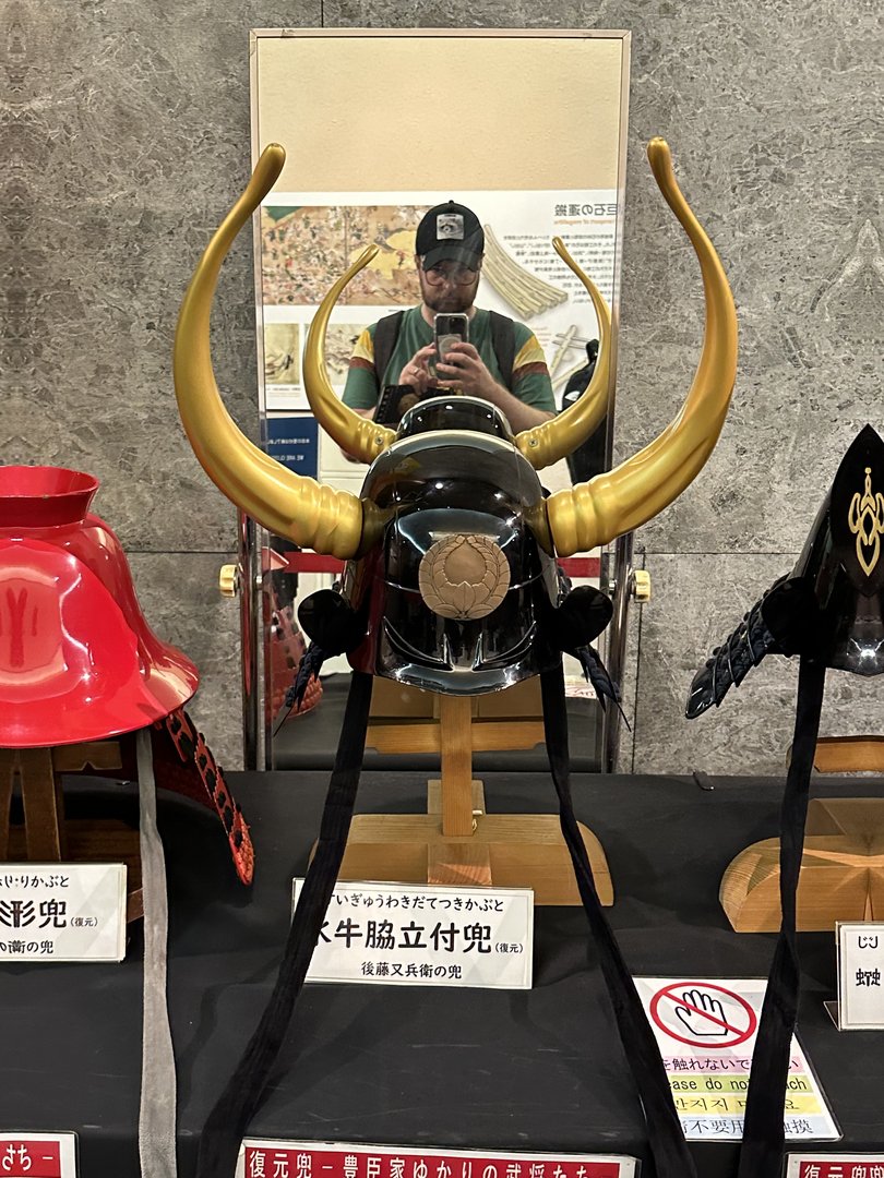 dan checking out the samurai helmet collection at osaka castle museum - this kabuto with golden horns was worn by tokugawa warriors