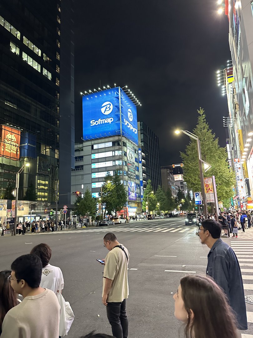 night scene outside sofmap in akihabara. christina checking her phone while we waited in one of those MASSIVE lines you always see in tokyo.