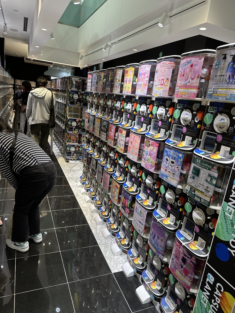 checking out the ENDLESS wall of gacha machines in dotonbori - these things are everywhere in osaka