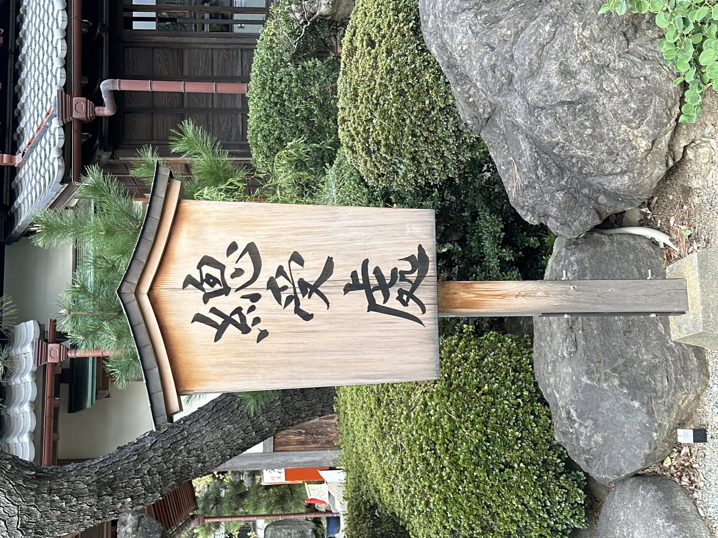 traditional wooden sign with kanji characters spotted at a temple garden in kyoto