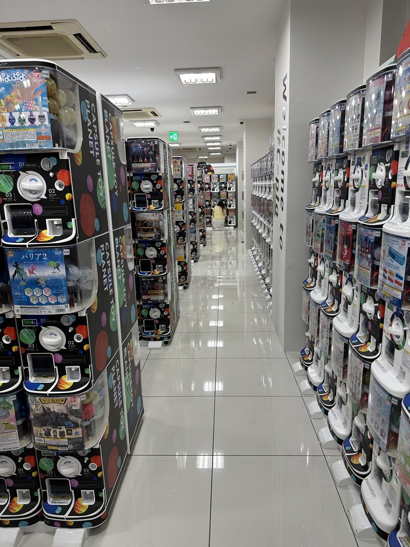 stumbled into this WILD gashapon paradise near dotonbori - endless rows of capsule machines with everything from anime figures to miniature food