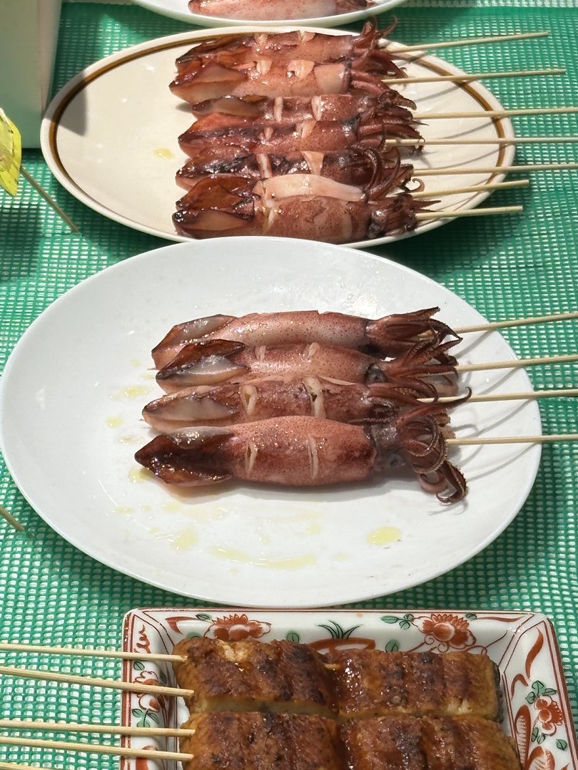 lunch near nishiki market - dan and christina tried their first ika (squid) yakitori. the MASSIVE squid skewers were way better than expected.