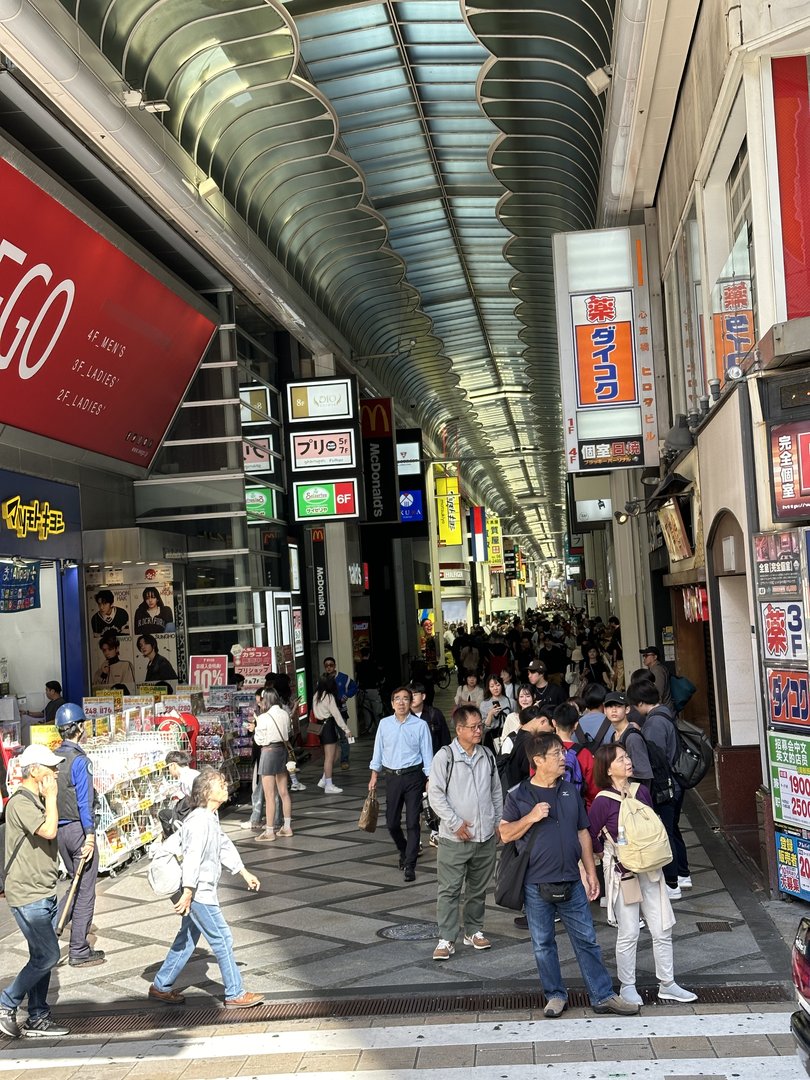 mid-morning crowds starting to build in osaka's famous dotonbori shopping arcade - this covered walkway stretches for what feels like MILES